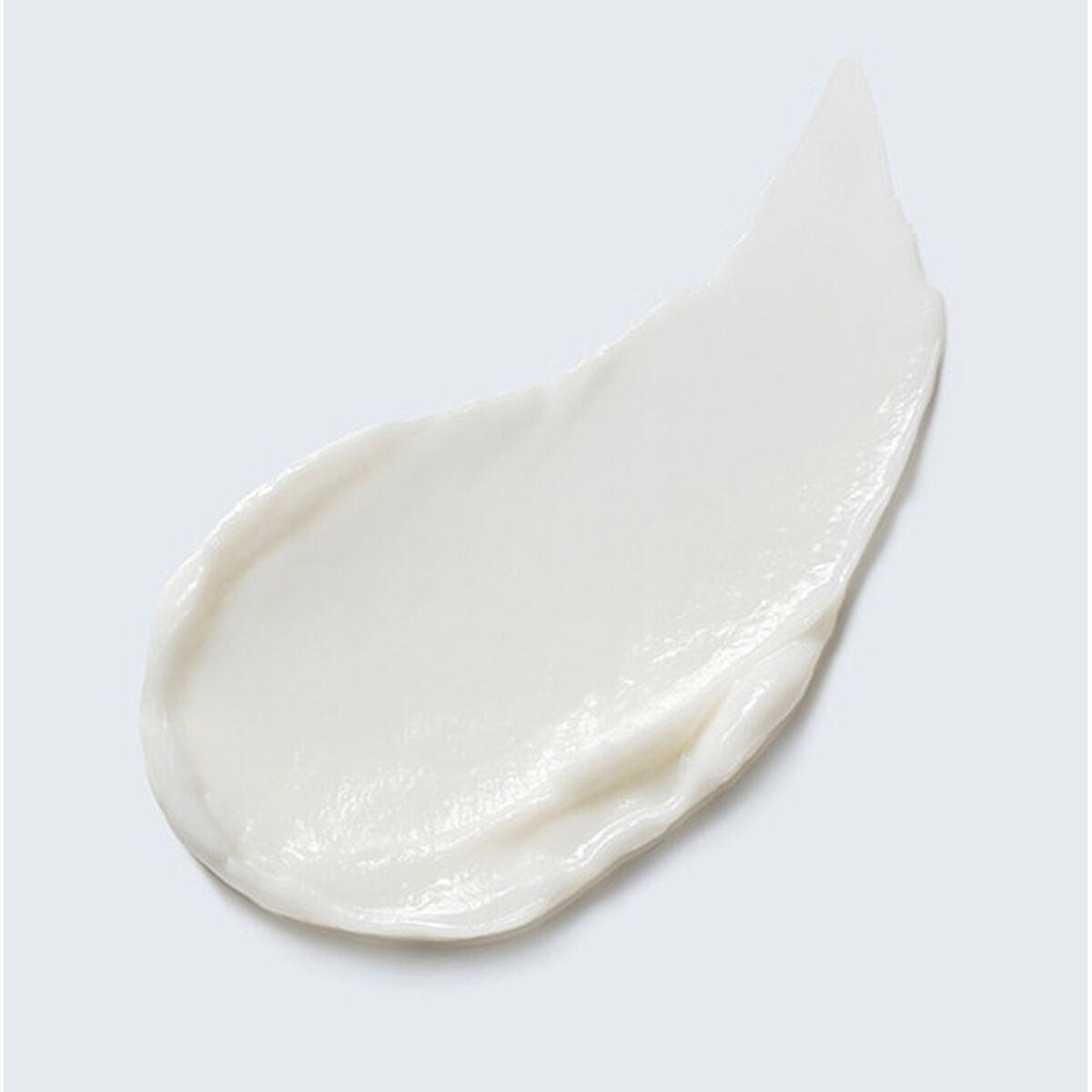Textured cream sample from Estee Lauder's Revitalizing Supreme+ moisturizer on a gray background.