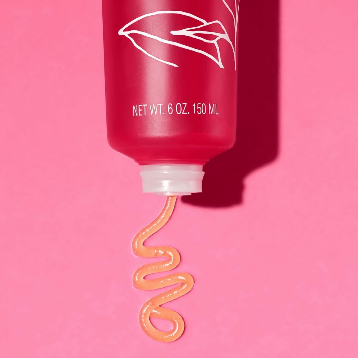 Melvita L'OR ROSE lotion bottle with pink background, showcasing the rich body lotion texture.