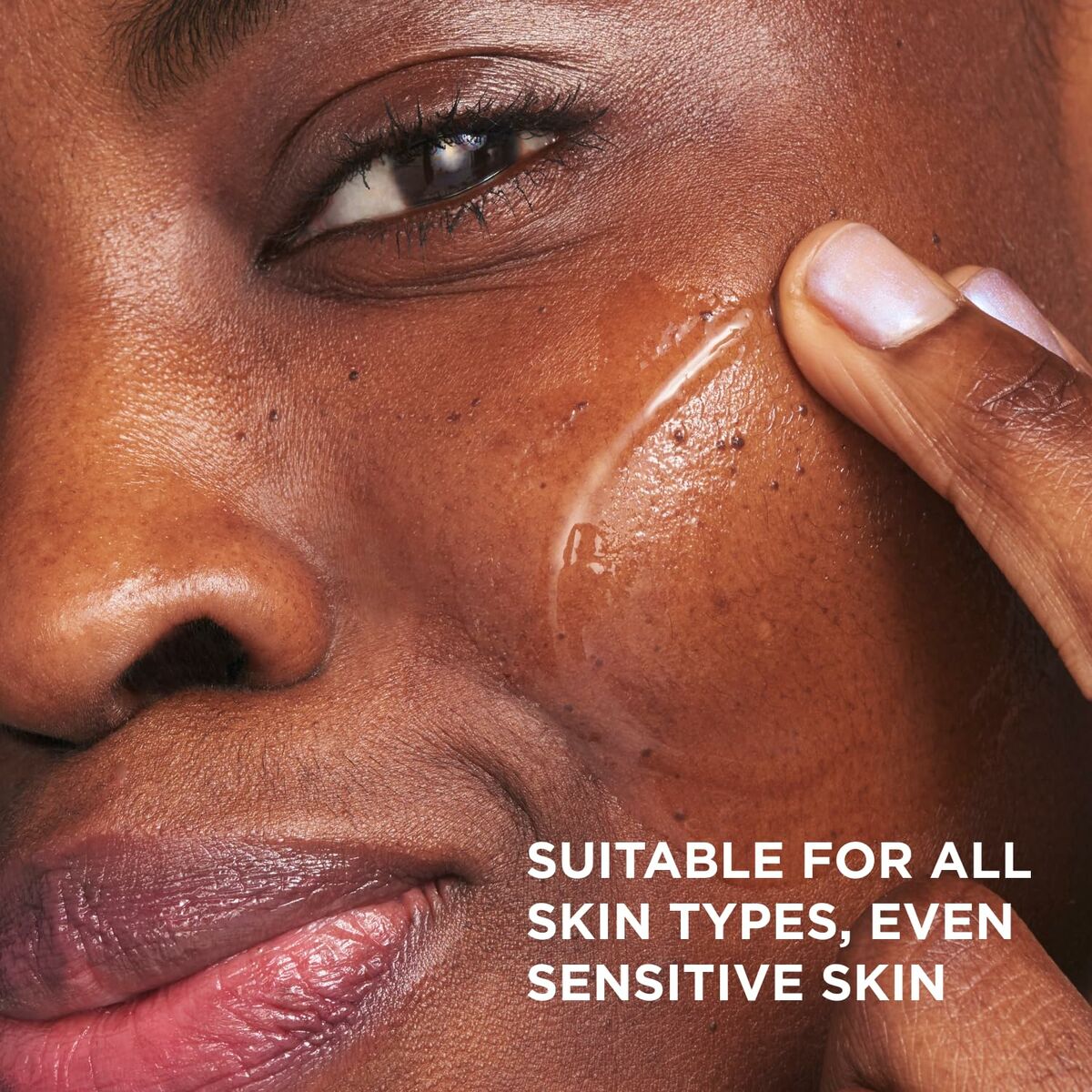 Close-up of a woman applying skincare, highlighting suitability for all skin types, including sensitive skin.