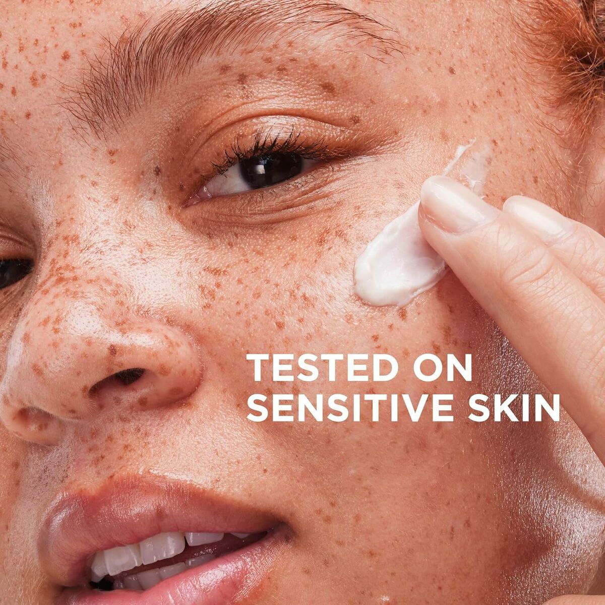 Close-up of a person applying cream, labeled 'Tested on Sensitive Skin,' highlighting skincare effectiveness.
