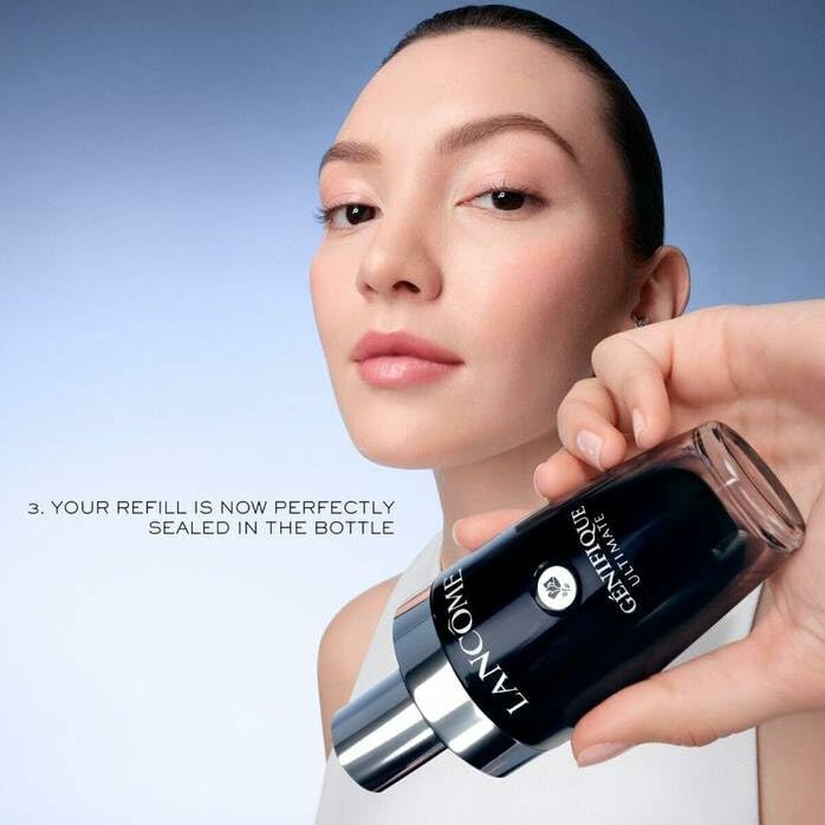 Model showcasing Lancôme GÉNIFIQUE refillable serum bottle, emphasizing sustainable beauty routines.