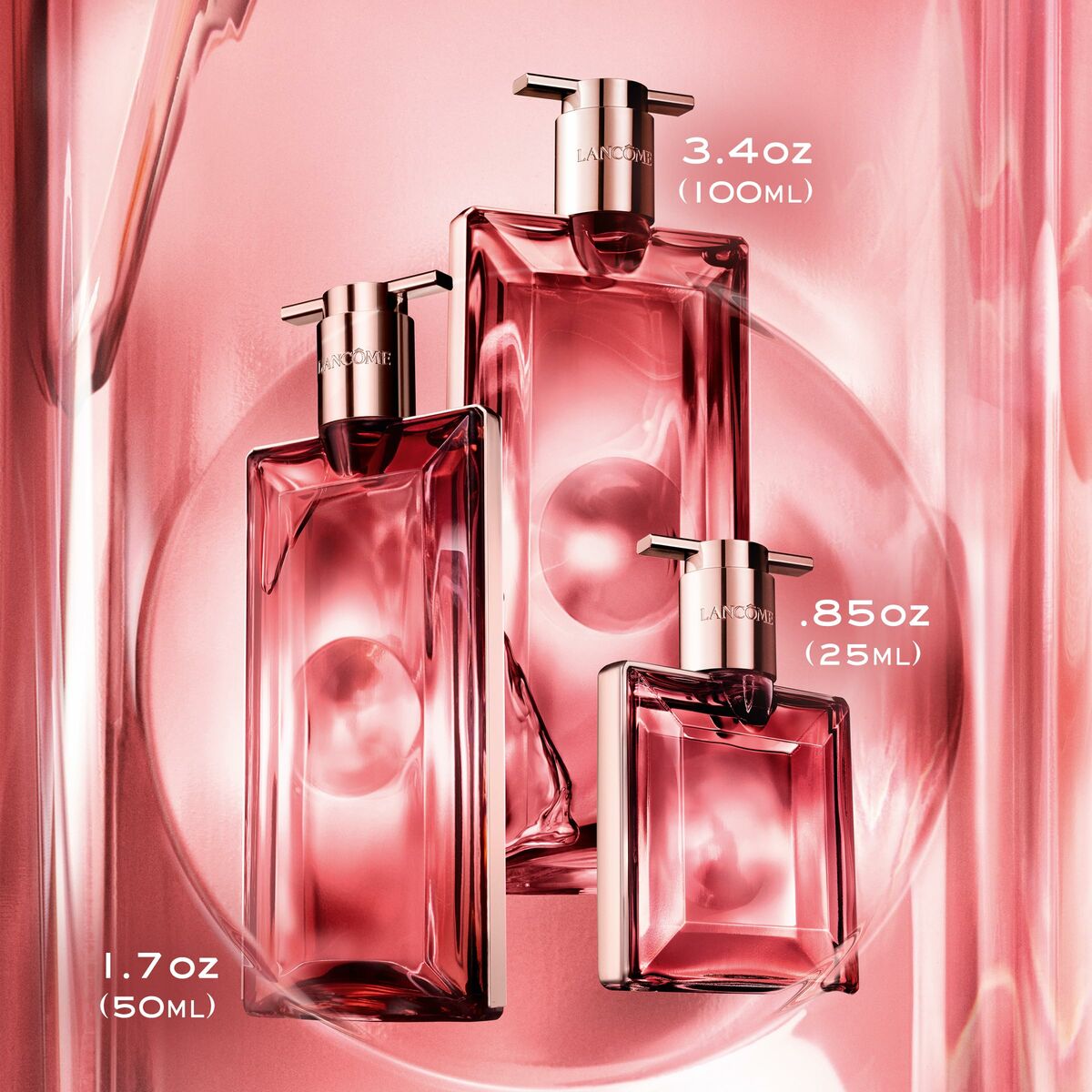Bottles of Lancôme Idôle EDP in 25 ml, 50 ml, and 100 ml sizes against a pink background.