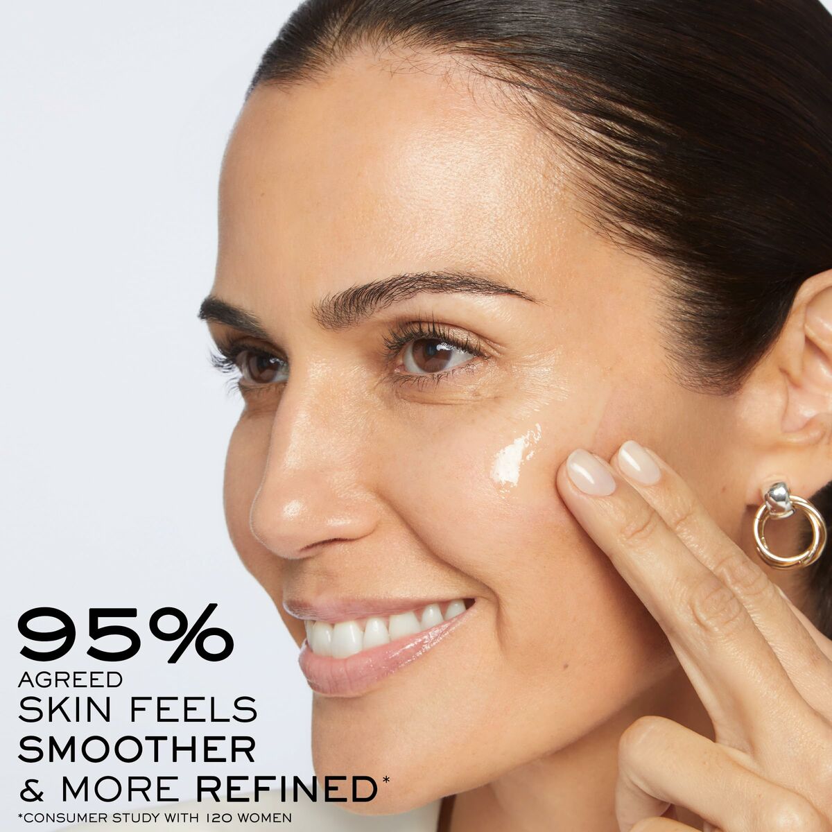 Woman applying Lancôme RÉNERGIE cream, showcasing smoother and refined skin results.