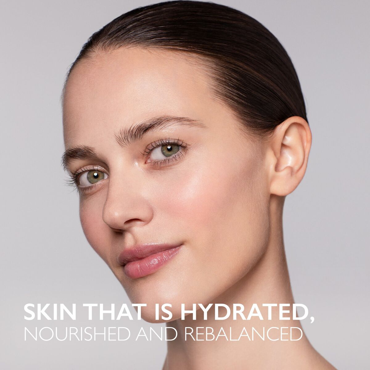 Close-up of a woman with glowing skin, emphasizing hydration and nourishment for a rebalanced complexion.