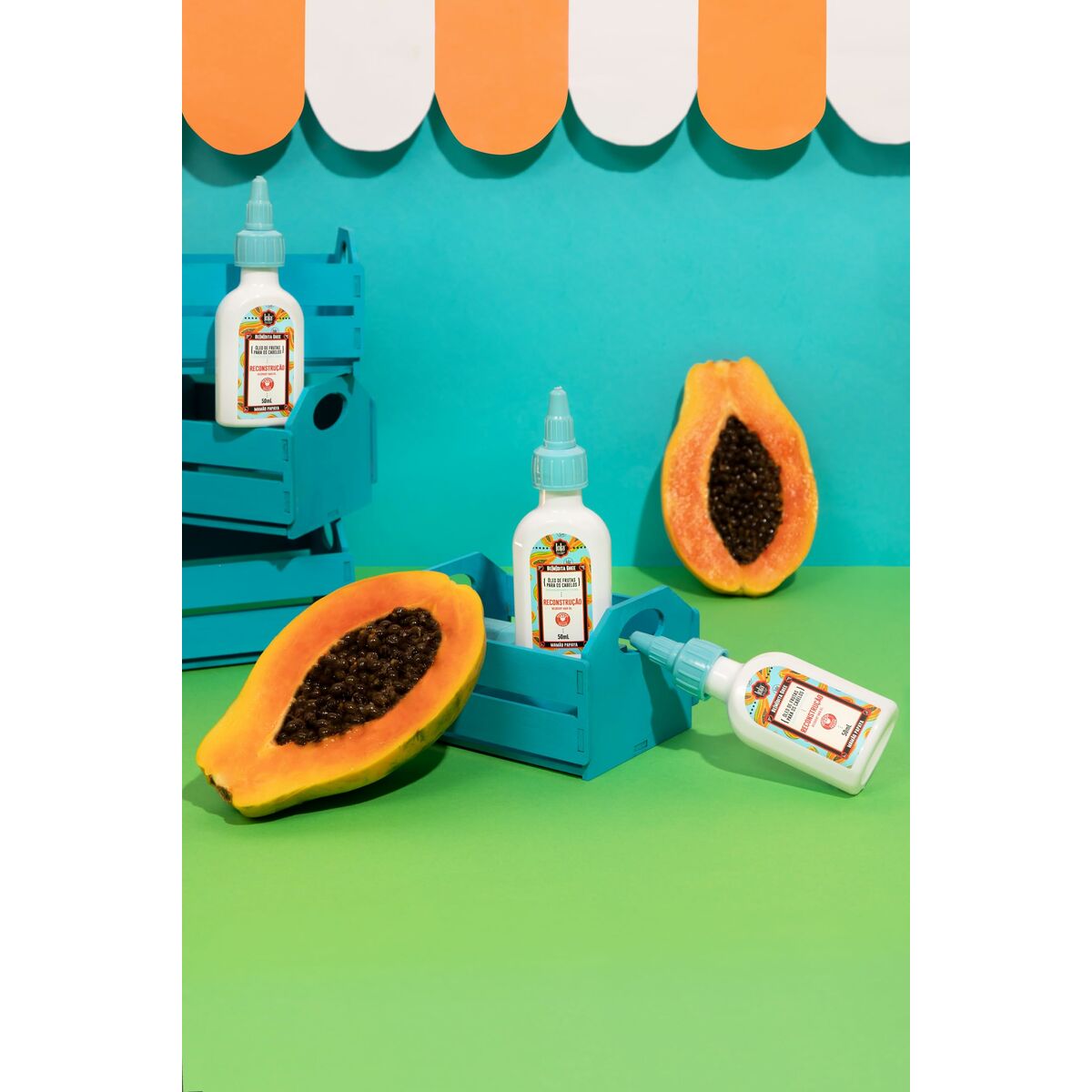 Bottles of hair product surrounded by fresh papaya on a colorful display, showcasing vibrant cosmetic branding.