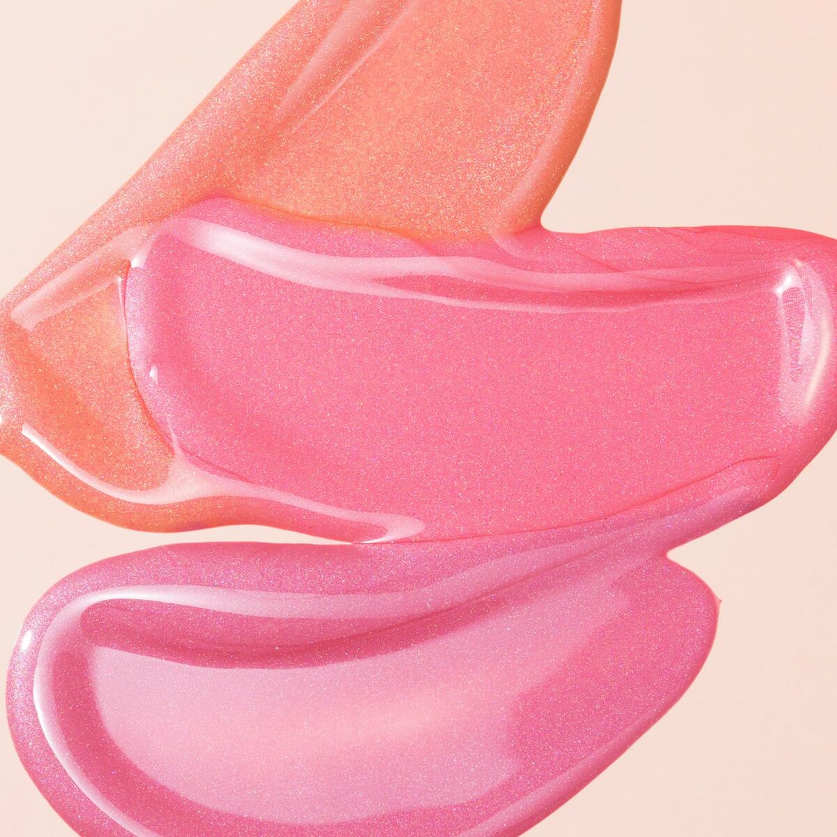 Textures of shimmering pink and orange makeup creams, perfect for the Collistar NOT Makeup Set.