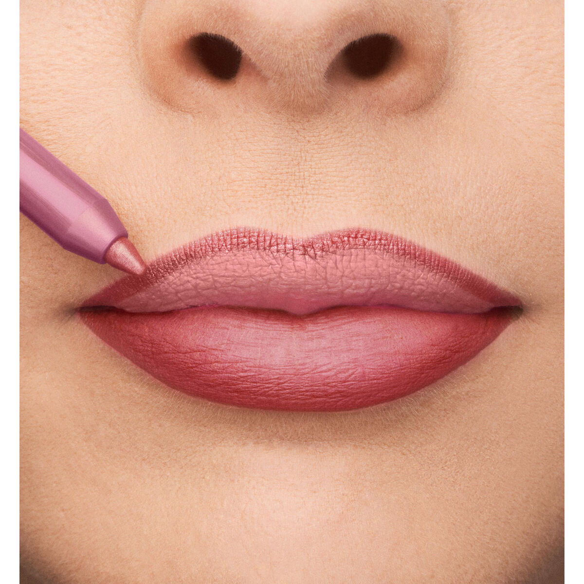Application of Collistar Professionale Nº 5-Rosa Deserto lip product, showcasing soft pink lips.