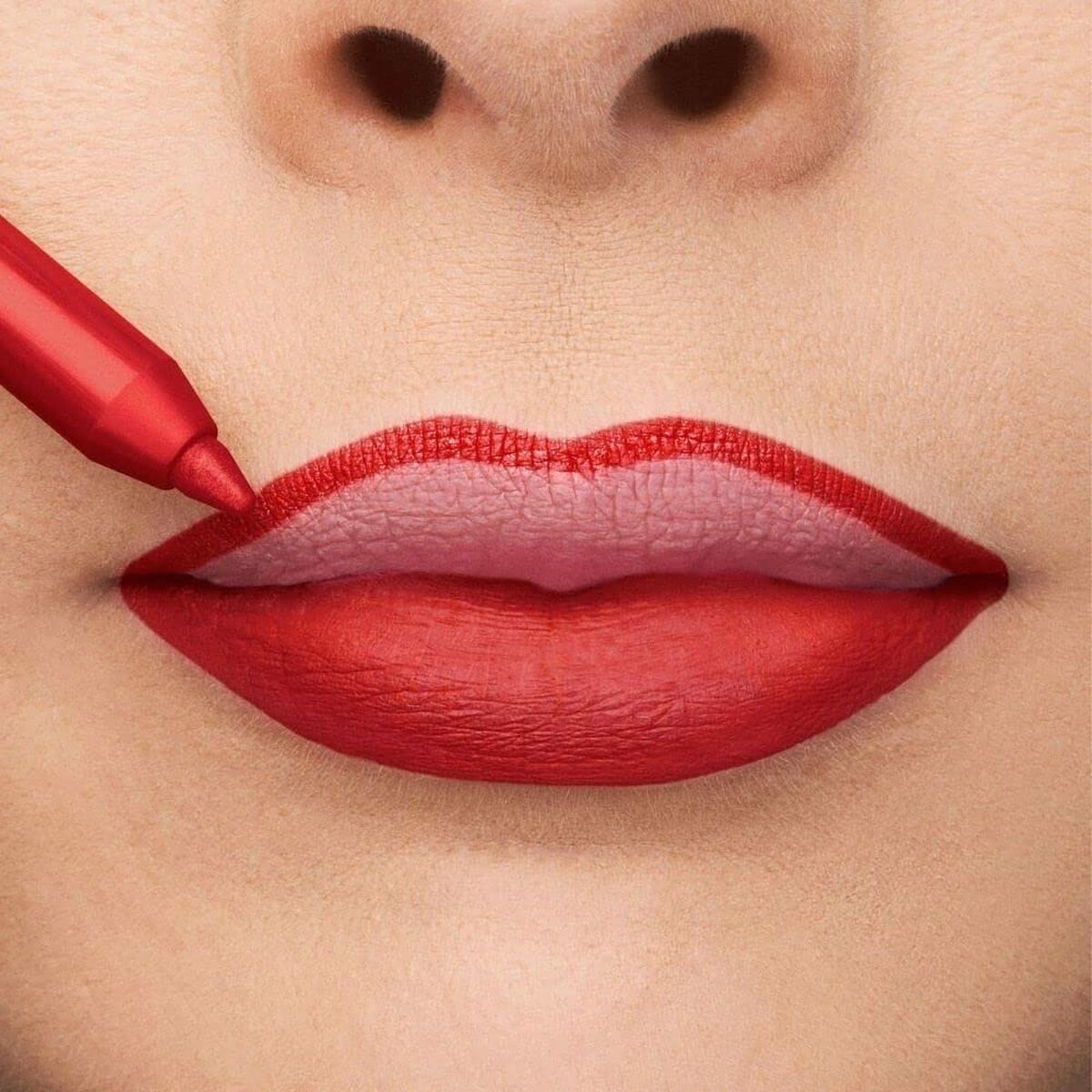 Close-up of lips being outlined with a red lip liner, showcasing the color application for a bold makeup look.