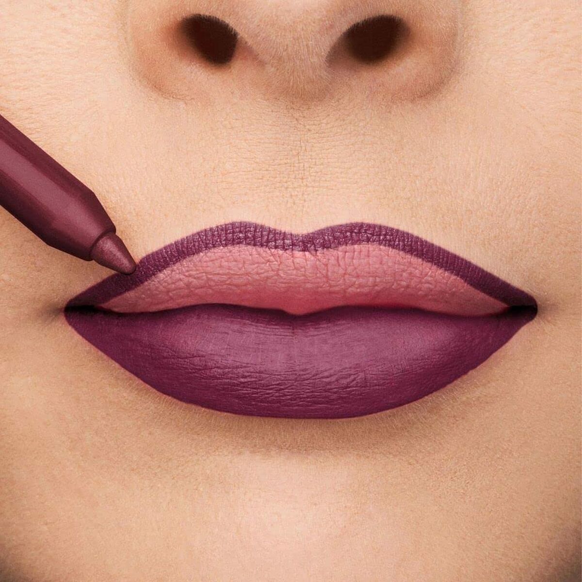 Close-up of lips being lined with a dark purple lip pencil, highlighting a bold makeup look.