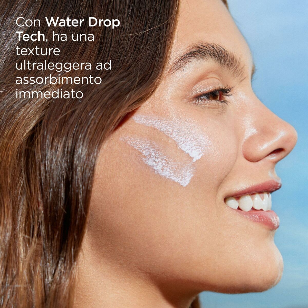 Woman applying ISDIN sunscreen with Water Drop Tech for instant absorption on her face.