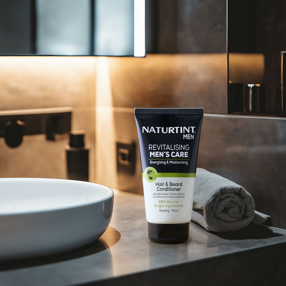 Naturtint MEN Revitalising Hair & Beard Conditioner on bathroom counter with towel and bowl.
