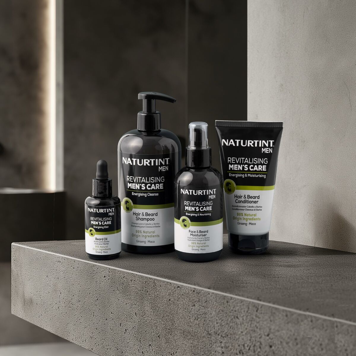 Naturtint MEN revitalising men's care products including shampoo, conditioner, and serum on a modern bathroom countertop.